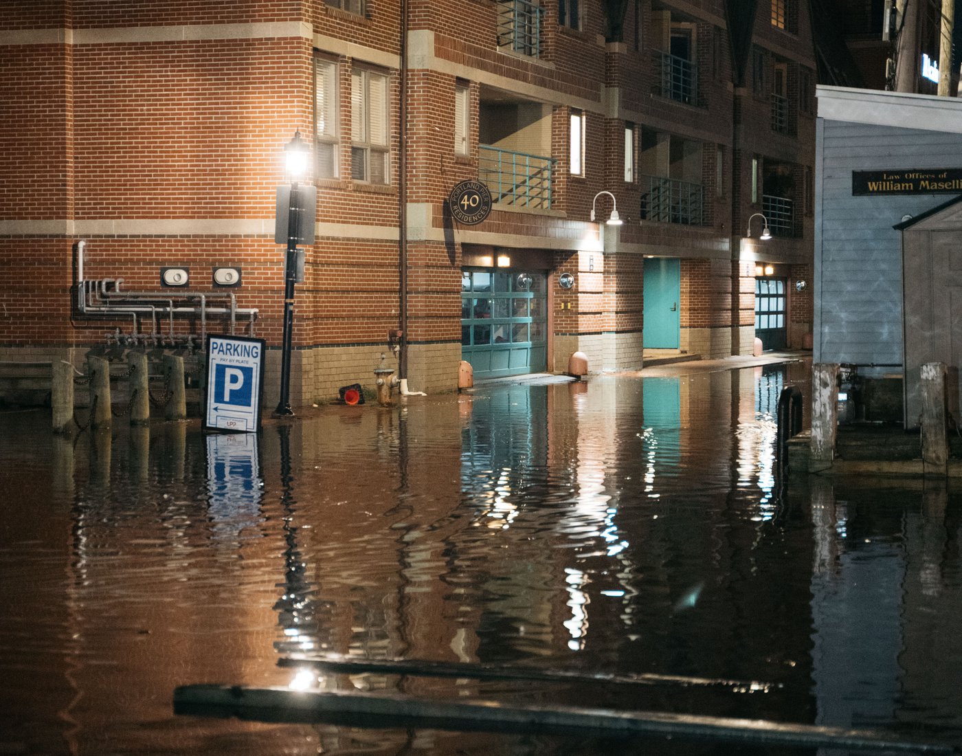 A flooded working waterfront scene captured during a particularly high tide.