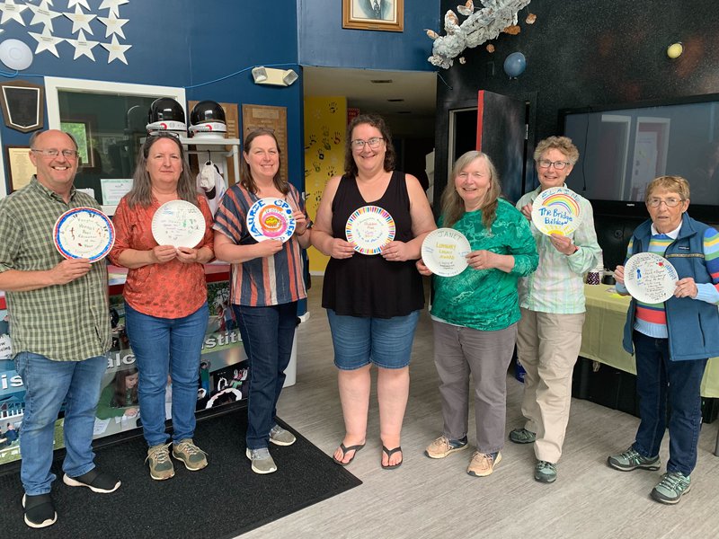 Group of educators from aroostook county holding up local awards they gave each other